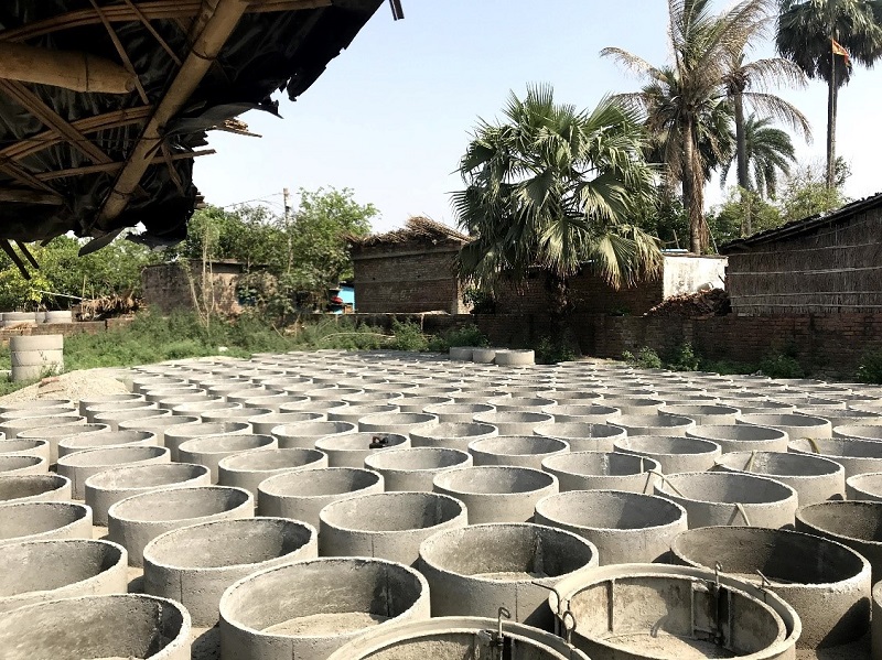 rows of cement pit toilet rings in India