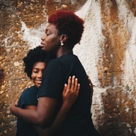 African American mother comforts child
