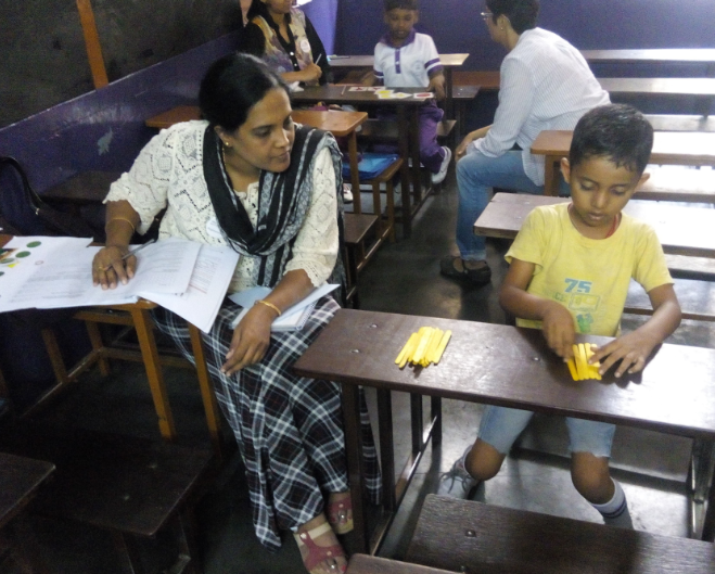 Teacher with student in a classroom