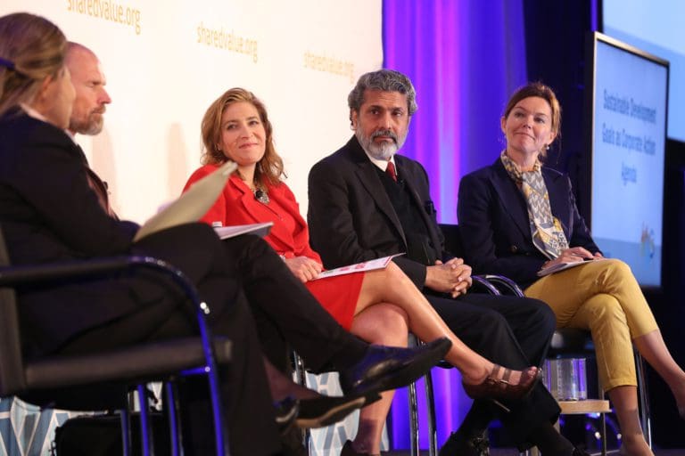 Five people sitting on chairs on conference panel