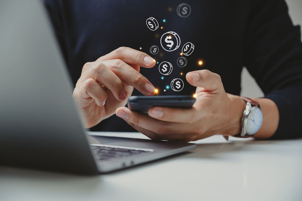 Hand of businessman using smart phone with coin icon,