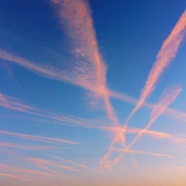 pink contrails in a blue sky