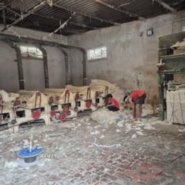 Two people working in a cotton processing facility