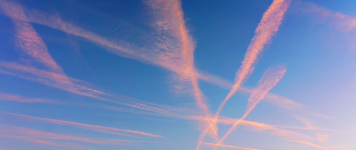 pink contrails in a blue sky